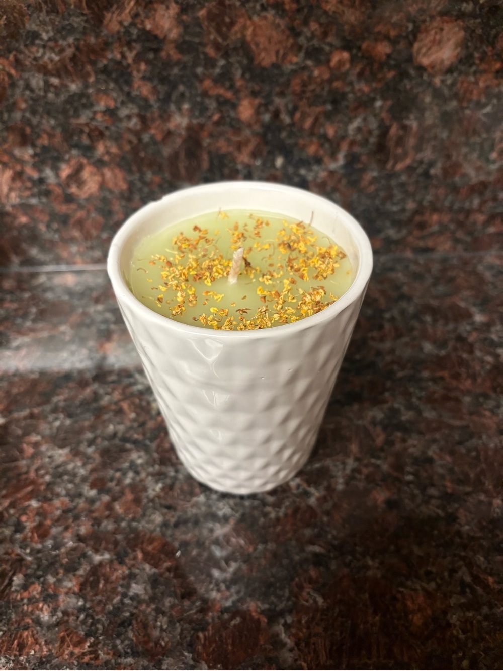 Handmade upcycled candle pear scented in a small vase with yellow flower petals
